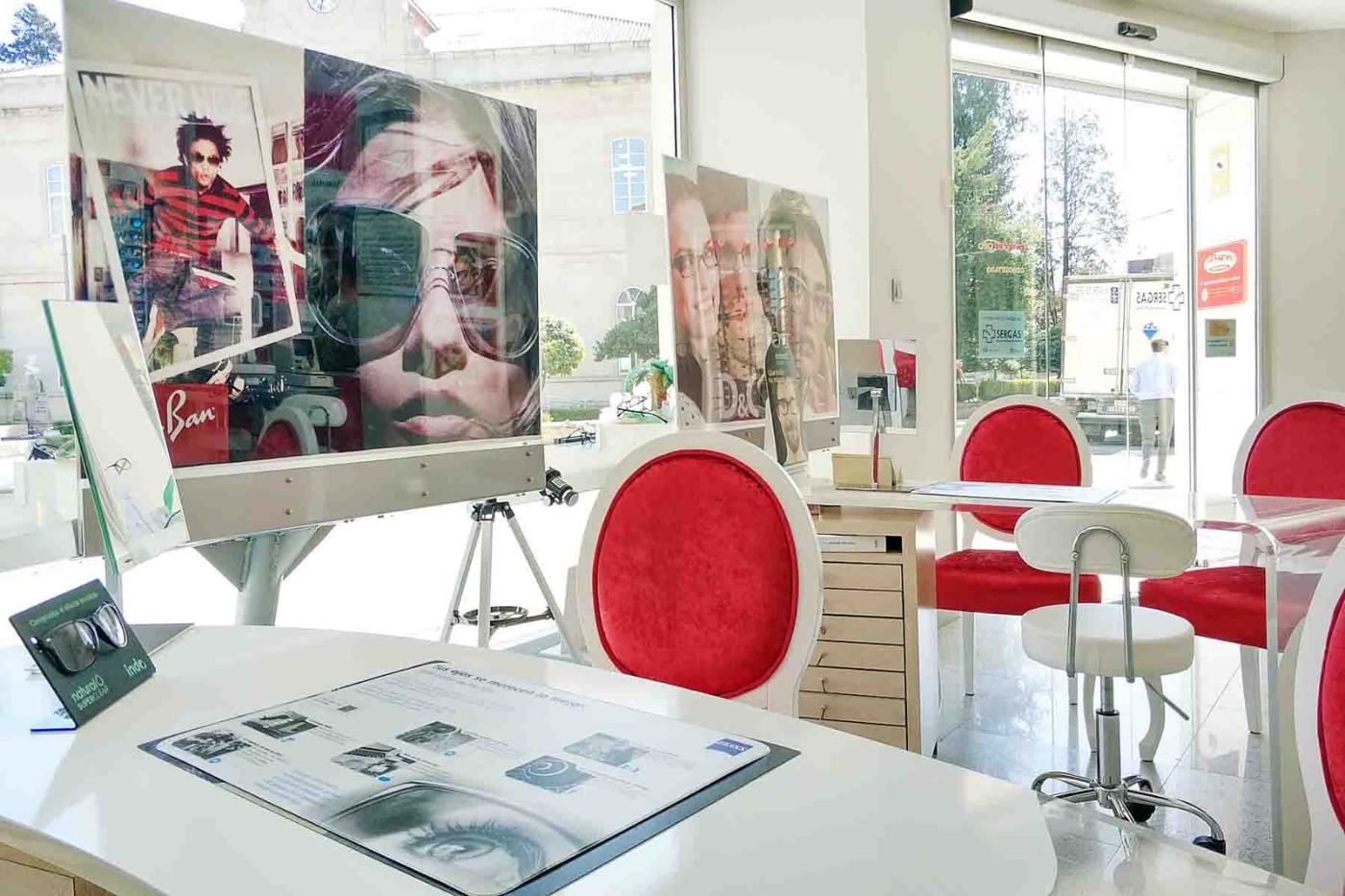 Zona de atención de la óptica con sillas rojas
